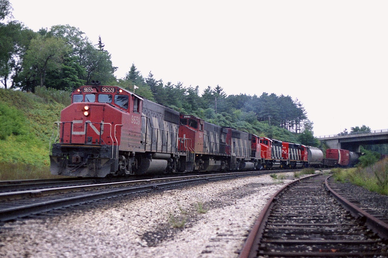 According to my notes, this was the last train I saw on a rather productive Wednesday away from work. It is late day and the sun fortunately is behind cloud, otherwise this shot would be toast. Because the last two units, SD40-2 (wide) are brand-new and on their very first run, I went to Aldershot to get more photos of them as this eastbound worked the yard until sunset.  Power is CN 9659, 2541, 9452, 5299 and 5298. I did not record car count but two cabeese brought up the rear, #79523 and 79558. I miss the Zebra Stripes.........