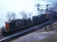 Here is one of those tough shots, but had to take it.  It was rare when I saw something like a C&O Geep in consist of a CN train back then.  This image of CN 4527, C&O 6153, CN 45xx rounding the bay out of Hamilton was made more difficult a capture due to the fact I am shooting against the sun and having contend with heavy mist/fog rising off the harbour, making detail offshore impossible. Interesting, I guess, just for the foreign GP. I think this is the only time I caught one in a CN train.