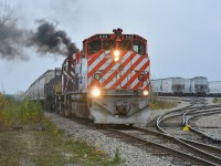 Recently acquired OSRX 644 and 505 smoke it up as they pull hoppers out of PDI Massey. They will head back across the Hanlon to switch on the North Guelph Spur after lifting cars from beside Gerdau Metals