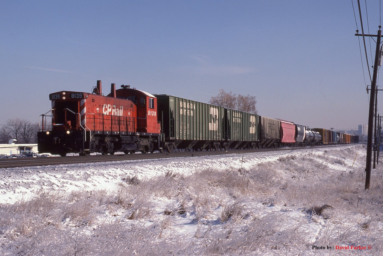 The previos nights freezing rain has given way to blue skies as the CP "Obico" switcher lead by lone SW1200RS 8139 runs across the Belleville Sub between Agincourt and Leaside at Don Mills