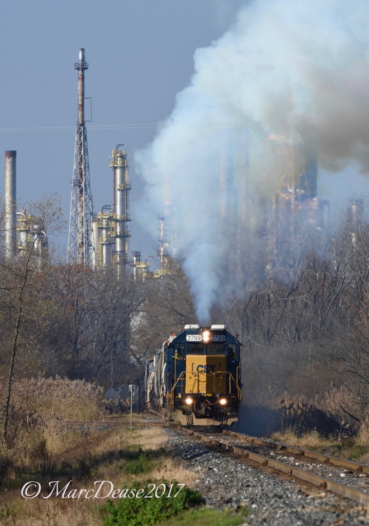 Having stopped to throw the switch the daily CSX in Sarnia lead by 2799 throttles up to speed spewing a large plume of smoke.
