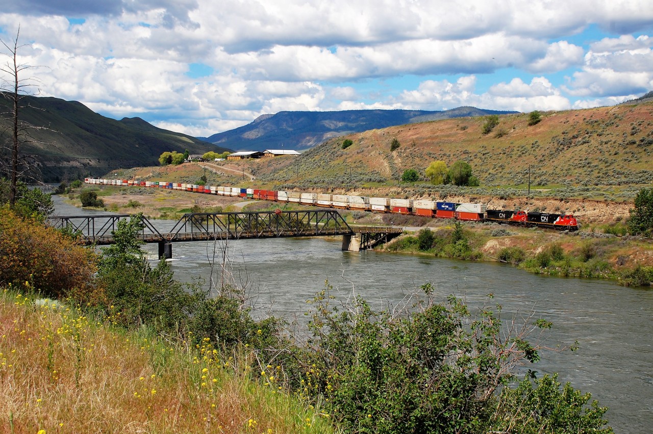 An eastbound Intermodal is seen passing the single lane road bridge at Walhachin. A warm and wet spring led to very high water levels in B.C. this year as evidenced by this view of the Thompson River.
