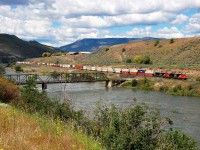 An eastbound Intermodal is seen passing the single lane road bridge at Walhachin. A warm and wet spring led to very high water levels in B.C. this year as evidenced by this view of the Thompson River.