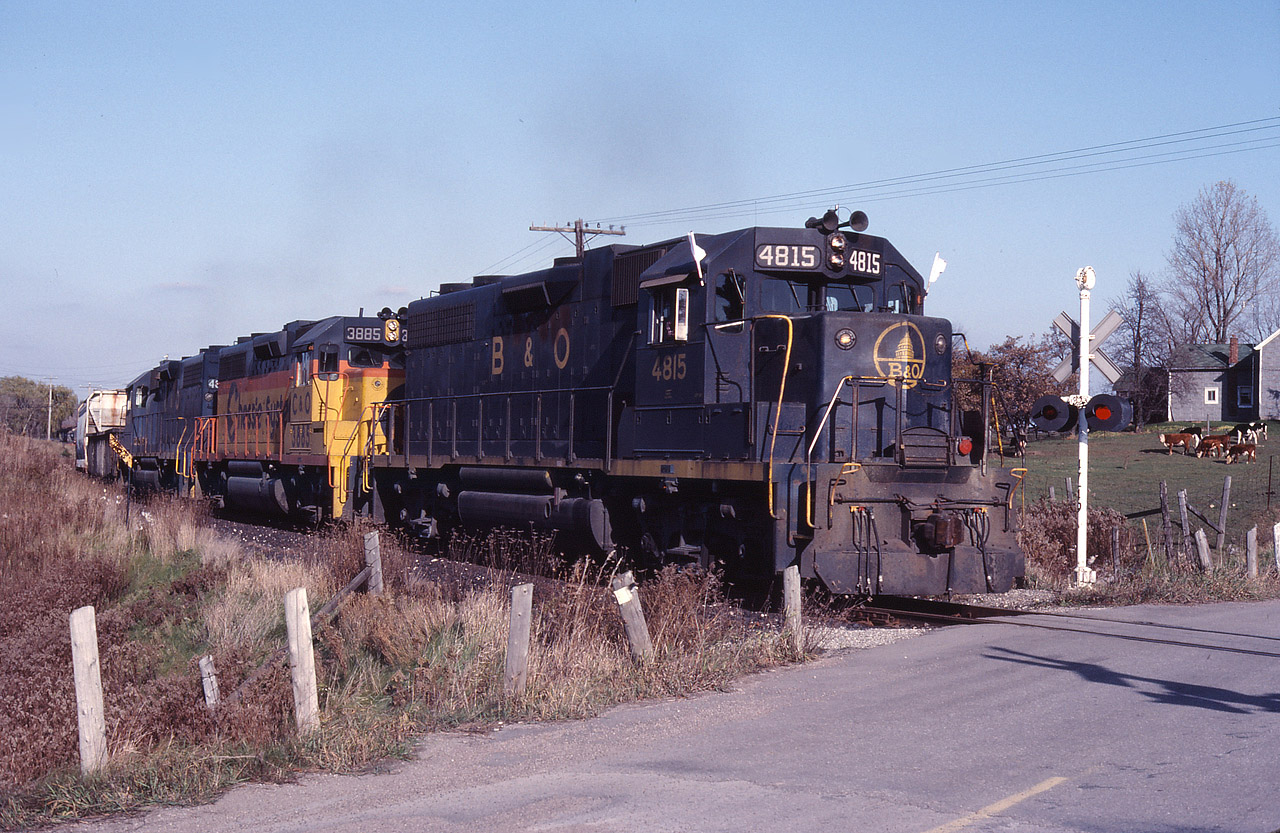 The TH&B West Local climbing up the grade and horseshoe curve at Summit, a stones throw from the CNR Dundas subdivision. If you were sitting at CNR Copetown and heard EMD's grinding up grade but didn't see them, it was the other hill - the TH&B that was providing the show. I'm sure this was nothing short of amazing. Note this is now the Hamilton-Brantford rail trail, and the farm is still there.