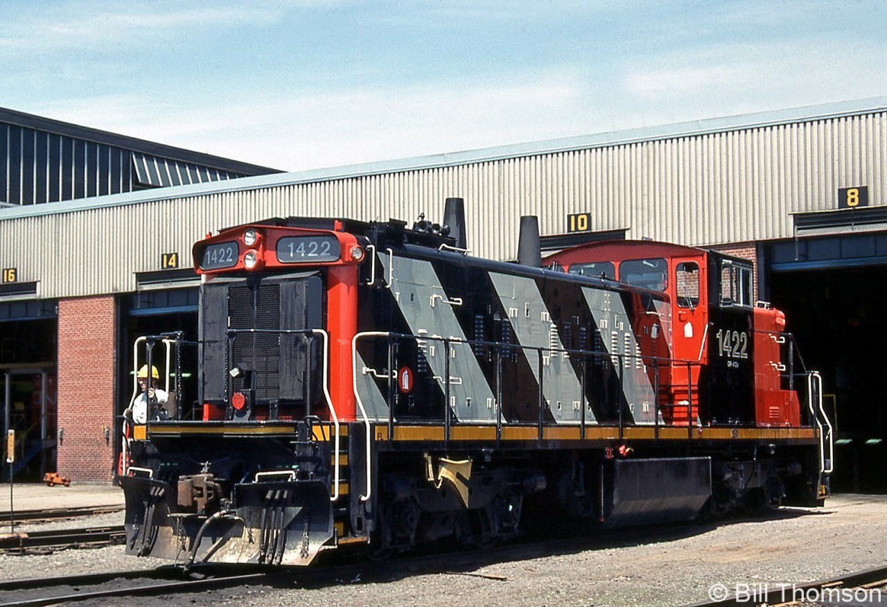 A fresh-looking CN GMD-1 1422 sits outside Taschereau Yard's diesel shop on May 26th 1990. Formerly CN 1076, she was rebuilt in 1989 with many of her sisters into the 1400-series units, which included an upgrade with 645 power assemblies and swapping the old A-1-A 3-axle trucks with B-B 2-axle Flexicoil trucks off lightweight GP9's (essentially making those GMD-1 into the equivalent of SW1200RS units but with a short hood and longer frame).