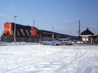 It is the second last day of 1981 and there is a seasonally amount of snow on the ground. Plus it is a nice crisp day. We are a few years into VIA, but CN RS-18s are still helping out. Note the number of passengers, and the ever present taxis.  Train travel was a lot easier back then. Not the best angle for shooting a train stopped at the Burlington West station, but I submitted it because it is different. And it is sunny!!  The station now leads a new life about a long block away, on Fairview Av, as the Freeman Station museum.  Passenger service has been relocated a half mile east at the GO complex.