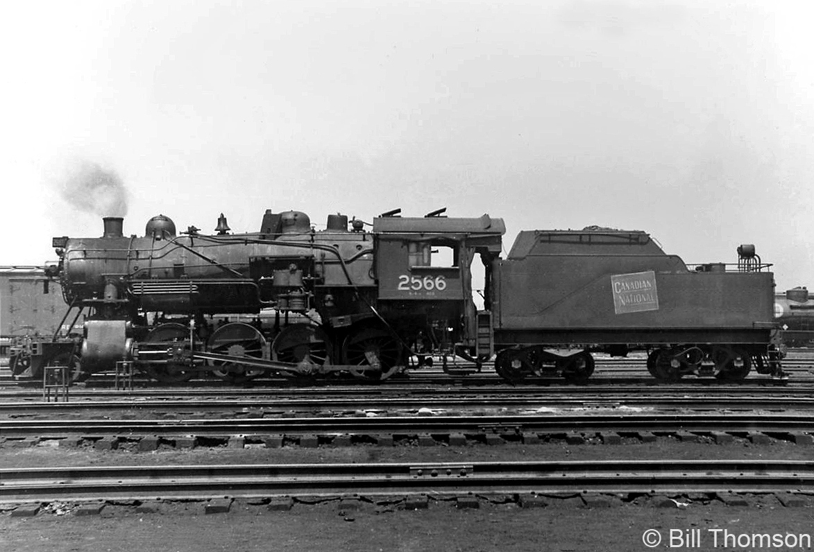 Canadian National N2a-class 2-8-0 "Consolidation" 2566 is pictured at CN's yard and roundhouse facilities in Mimico in 1954. Built by MLW as Grand Trunk Railway 704 in December 1906, 2566 was cut up for scrap in October of 1961 at the end of steam.