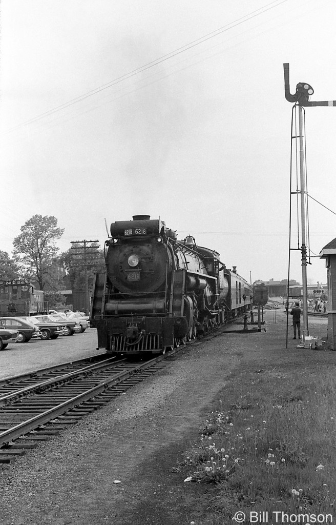 Canadian National U2g Northern 6218, well into her second career in excursion service, is shown paused at CN's Guelph Junction train order office in 1969. CN SW1200RS 1241 is visible in the background.