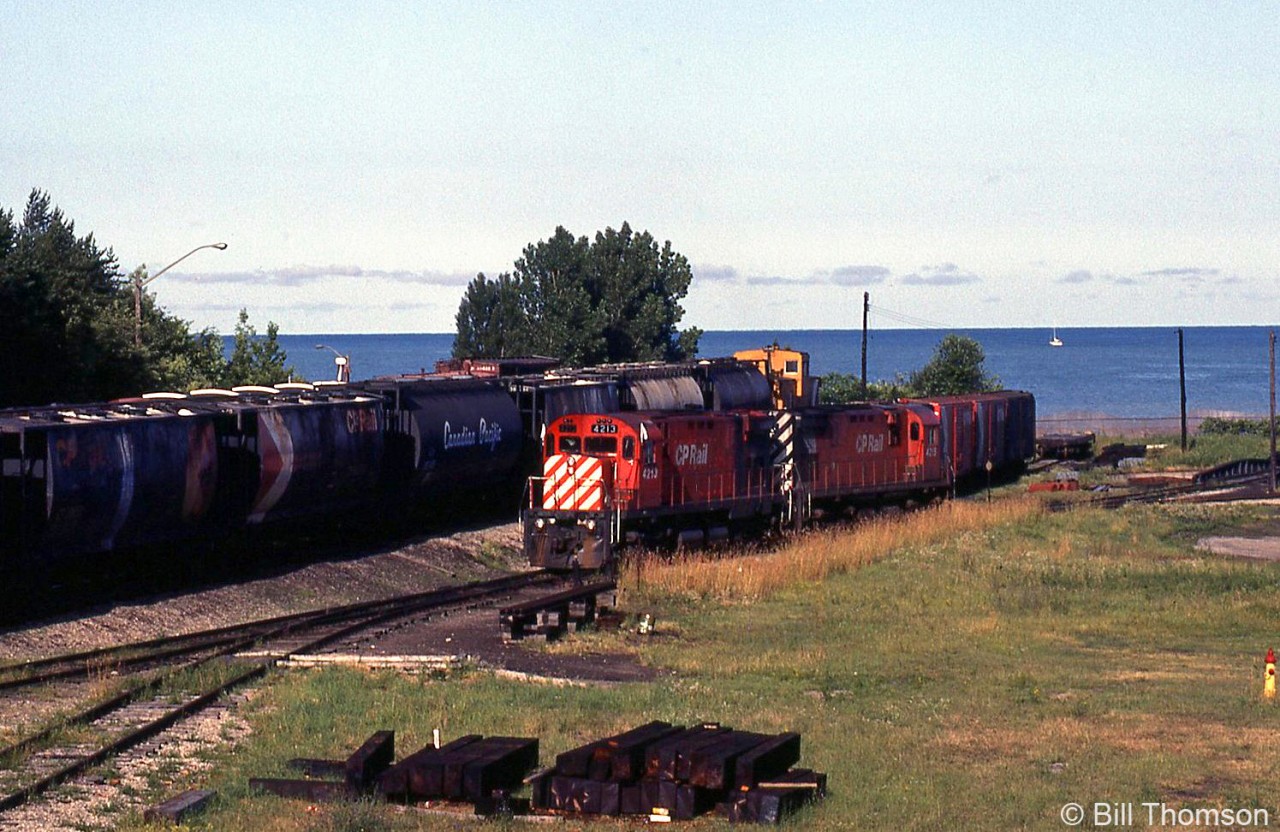 With Lake Huron in the background, CP C424's 4213 and 4215 are shown in Goderich yard in July 1983, ready to
return down the Goderich Sub to Guelph Junction. Note turntable on the right, and older cylindrical hoppers on the train.