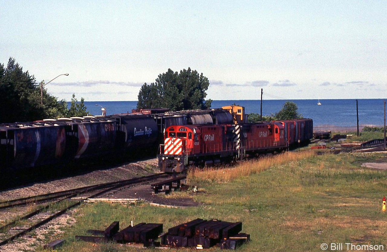 With Lake Huron in the background, CP C424's 4213 and 4215 are shown in Goderich yard in July 1983, ready to
return down the Goderich Sub to Guelph Junction. Note turntable on the right, and older cylindrical hoppers on the train.