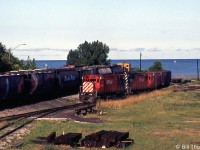 With Lake Huron in the background, CP C424's 4213 and 4215 are shown in Goderich yard in July 1983, ready to
return down the Goderich Sub to Guelph Junction. Note turntable on the right, and older cylindrical hoppers on the train.