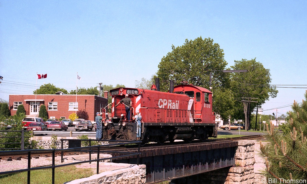 With crew riding the front porch, steps and footboards, CP SW1200RS 8108 crosses the Speed River in Guelph back on June 1st 1984, on the Guelph Junction Railway (The City of Guelph owns the line from Guelph Junction to Guelph). The CPR stopped serving the line in 1997, and Ontario Southland took over operations with their fleet of secondhand MLW's.