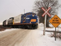 OSR 1400, 6508 & 1401 lead a long string of hoppers from Putnam into Ingersol passing by Thomas Rd. just before entering Cami property. They would shove into Cami to retrieve a handful of autoracks, then head to Woodstock to interchange with CP.