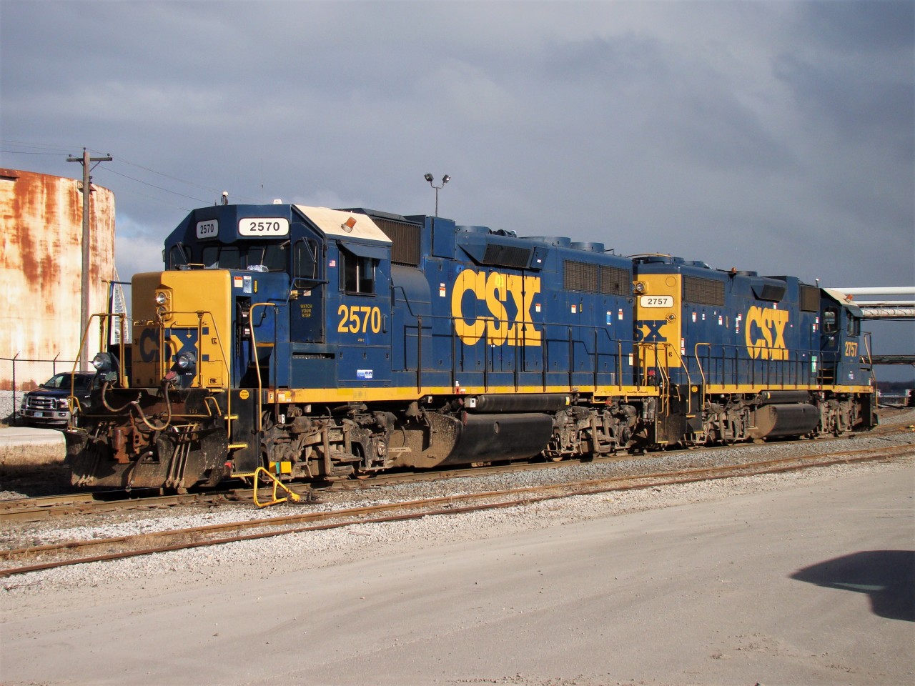 CSX power basks in the sun as the crew gathers inside the station, returning with a bag of gloves, before departing to switch Praxair and interchange with CN. The sun wouldn't last long however as a lake effect snow squall would soon blanket the area.