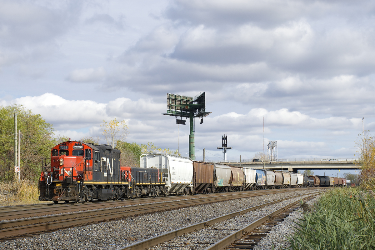For the second time in about an hour, CN 596 is leaving Southwark Yard for nearby Pointe St-Charles Yard on the other side of the Victoria Bridge as GP9 CN 7228 and slug CN 218 lead about twenty cars westwards.