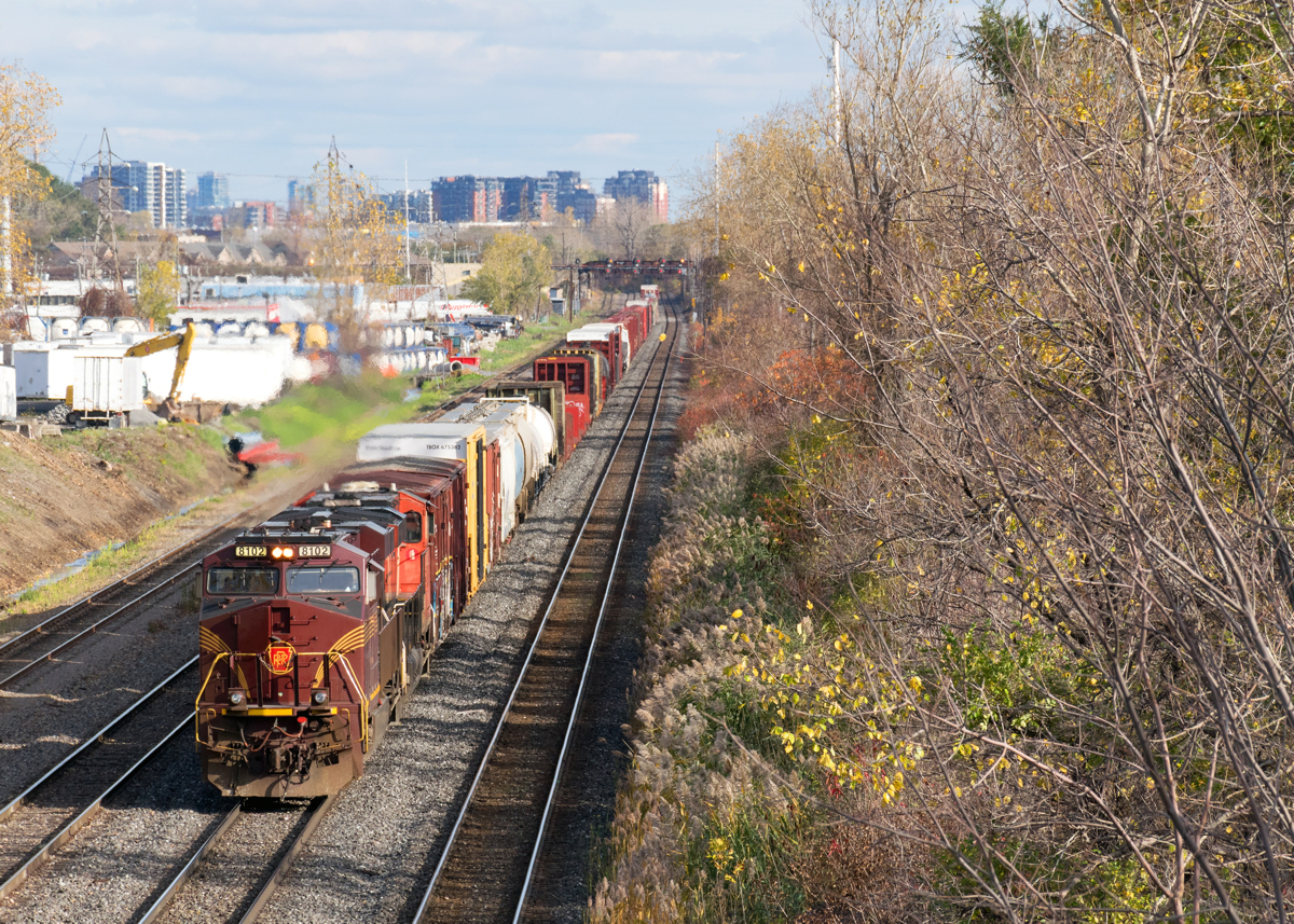 Heritage unit NS 8102 is leading CN 527, nearly into Taschereau Yard with 76 cars from Southwark Yard.