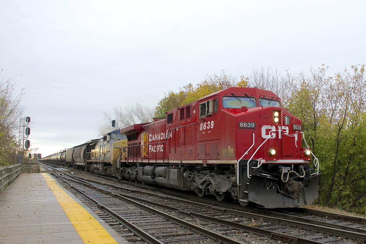CP 651 with repainted CP 8639 and faded CSXT 7650 is through Lasalle Station on a grey morning.