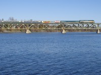  VIA 622 has unwrapped VIA 902 leading 4 LRC cars in 4 different paint schemes at it crosses the Richelieu River at Otterburn Park.