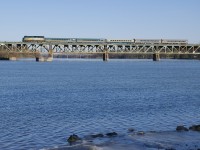 Some ice has formed along the shore of the Richelieu River on the second day in a row that Quebec has had well below freezing temperatures, as VIA 35 crosses the river with VIA 6445 leading a mixed consist of five cars.