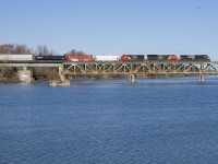 <b>An unexpected train and an unexpected leader.</b> I was surprised by an eastbound crossing the Richelieu River on CN's St-Hyacinthe Sub not too long after CN 120 passed, it had NS 9512, CN 3080 & CN 9584 and perhaps 20-30 cars. I found out later it was CN 527, heading east out of Southwark Yard; 99% of the time CN 527 heads west out of Southwark Yard for the island of Montreal. While NS leaders are relatively common out of Montreal, they are rare this far east on the St-Hyacinthe Sub.