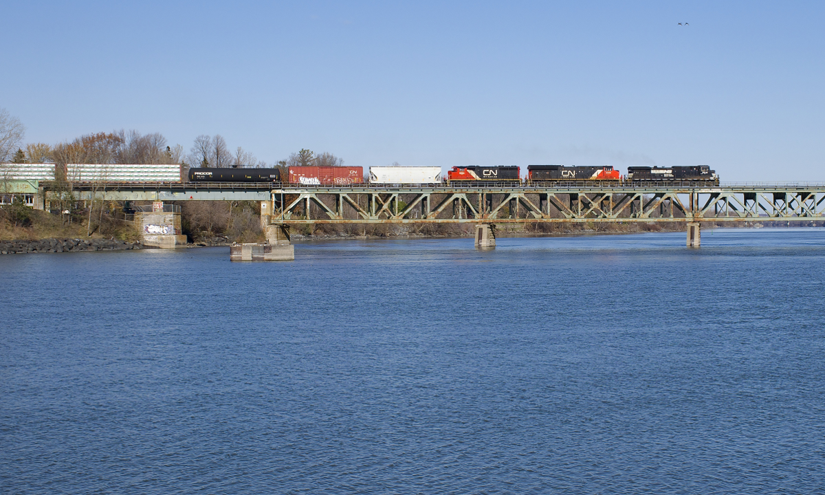 An unexpected train and an unexpected leader. I was surprised by an eastbound crossing the Richelieu River on CN's St-Hyacinthe Sub not too long after CN 120 passed, it had NS 9512, CN 3080 & CN 9584 and perhaps 20-30 cars. I found out later it was CN 527, heading east out of Southwark Yard; 99% of the time CN 527 heads west out of Southwark Yard for the island of Montreal. While NS leaders are relatively common out of Montreal, they are rare this far east on the St-Hyacinthe Sub.