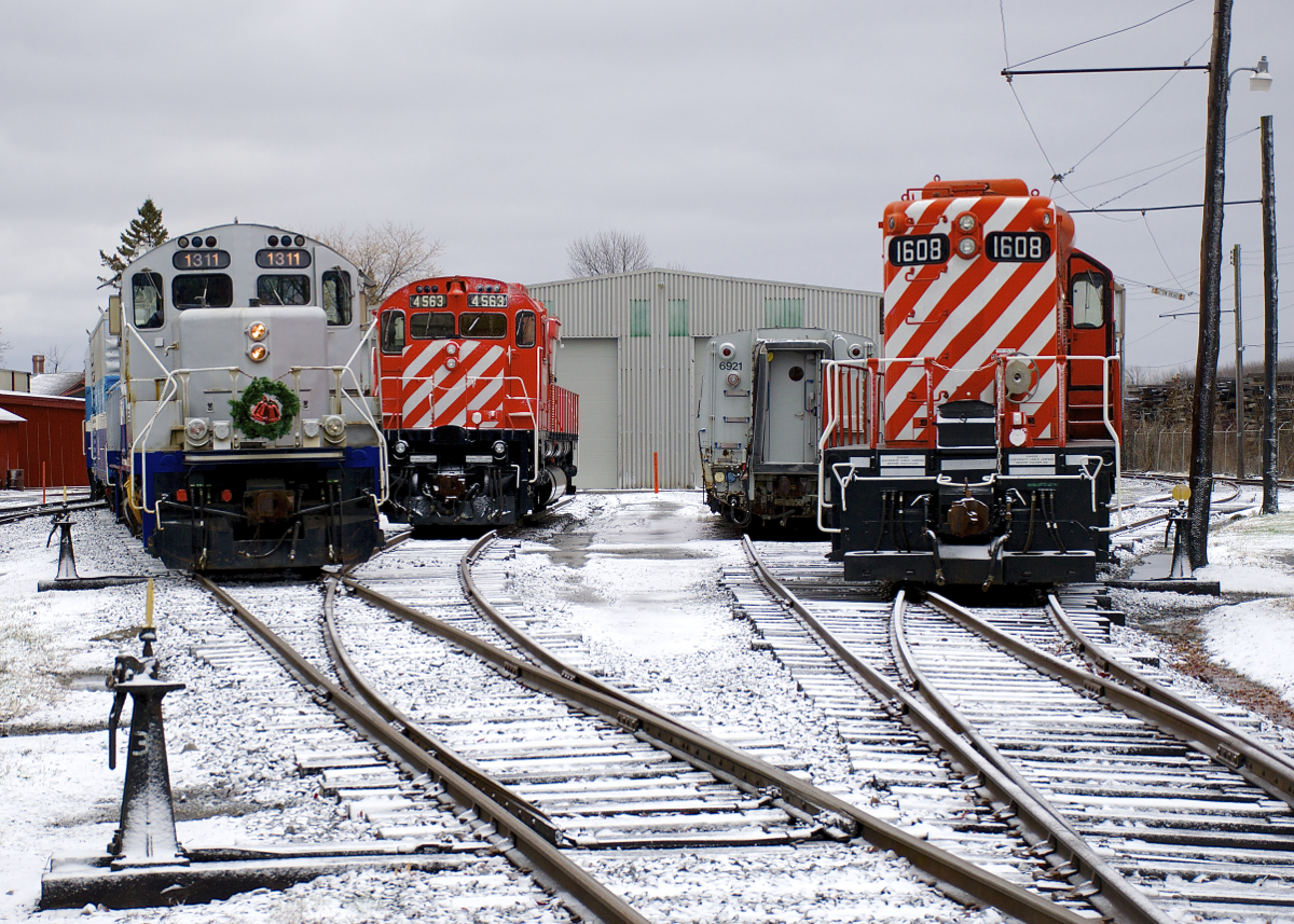Exporail's Christmas Train (with a rare all-AMT consist of GP9 AMT 1311, generator car AMT 603 and coach AMT 827) approaches Hays Station to pick up another round of passengers. At right is M-636 CP 4563, LRC-3 VIA 6921 and GP9 CP 1608.
