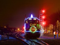 The U.S. version of CP's Holiday train is stopped beside the small yard at Delson as it makes its third stop of the night, with the head end stopped beside a new set of signals on CP's Adirondack Sub.