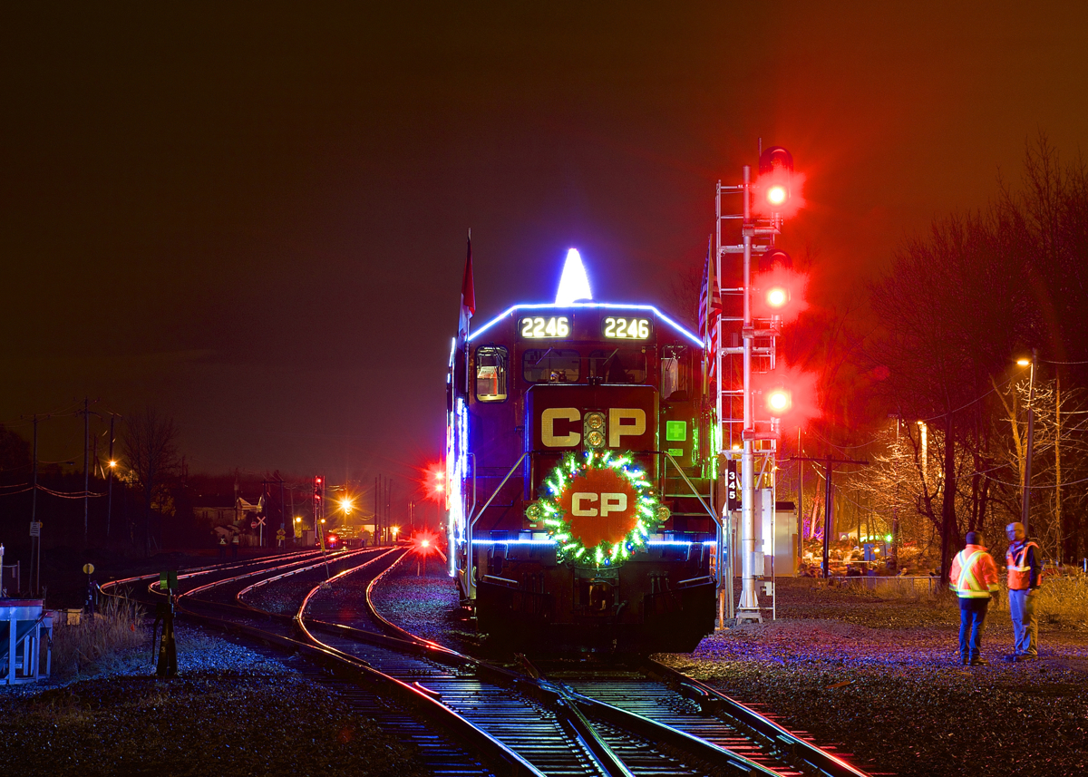 The U.S. version of CP's Holiday train is stopped beside the small yard at Delson as it makes its third stop of the night, with the head end stopped beside a new set of signals on CP's Adirondack Sub.