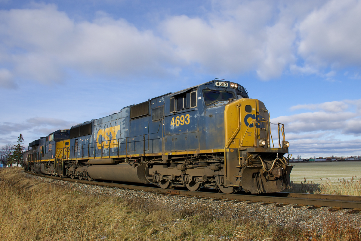CN 327 is leaving the Kingston Sub as CSXT 4693 & CSXT 3255 lead 103 cars onto the Valleyfield Sub at Coteau.