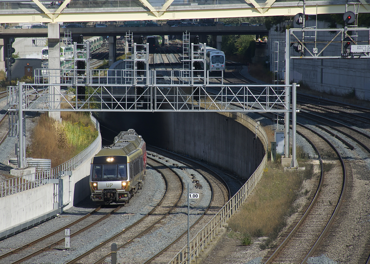 A three-car Union Pearson Express train is westbound on the flyunder west of Union Station in Toronto.