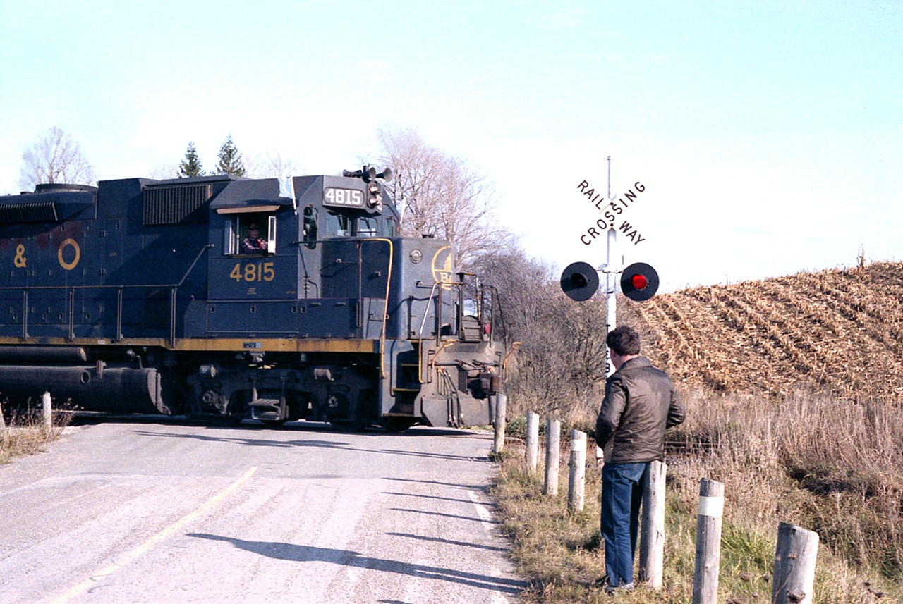 In regards to RP pic #31269, I just felt the need to prove Doug's great shot for what it was by submitting this sneaky image of him watching the train pass by. Rarer still would be a picture of him waving. Never caught him at it. :o)  This occasion was the very first run of the TH&B version of the "Nanticoke".
We hopefully are going to see some marvellous photos of Dougs on Railpics in the coming months.
