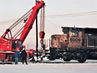 Still wearing it's Kansas City Southern white paint job, HLCX lease unit 5009 an SD40 built in 1966 gets a lift by the Pettibone mobile crane after derailing it's front truck.