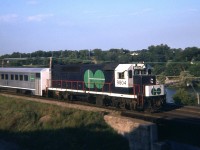 I used to enjoy those warm summer nights on the hillside at Bayview Jct. Back when there was no hassles, no strange characters, ....nothing to bother me but the bugs. The sweet memories returned as I looked at this image. Armed with an almost useless camera, pegged at 1/25th second, anything moving over 15 MPH required 'panning' to get some sort of decent photo. Which explains this one. I understand the 9804, originally 604, was renumbered to 504 in early 1975. I assume it was repainted then as well. Anyone have knowledge of when the repainting to white and green began and eventually was completed?