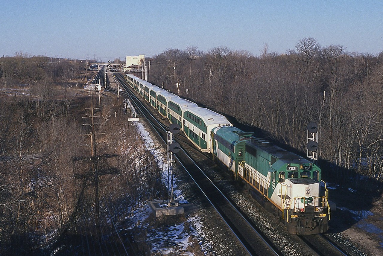 Sometimes with that anticipated return of spring there are those crystal clear days in which you think you can see from here to eternity. Crisp and dry. This was one of those. Sun in late day low in a cloudless sky. After work I took advantage of such in hopes of catching some interesting trains. Didn't work out that way. But now, 20+ years along, even the GO train now looks good. Here is G0 722 and APCU 900 as seen from Lemonville Rd bridge in Aldershot. The physical plant of course is all changed now, and the landmark Aldershot Cold Storage building in the distance is but a memory. The 722 was dealt off a couple of months after this photo, and the 900 was scrapped the following year.