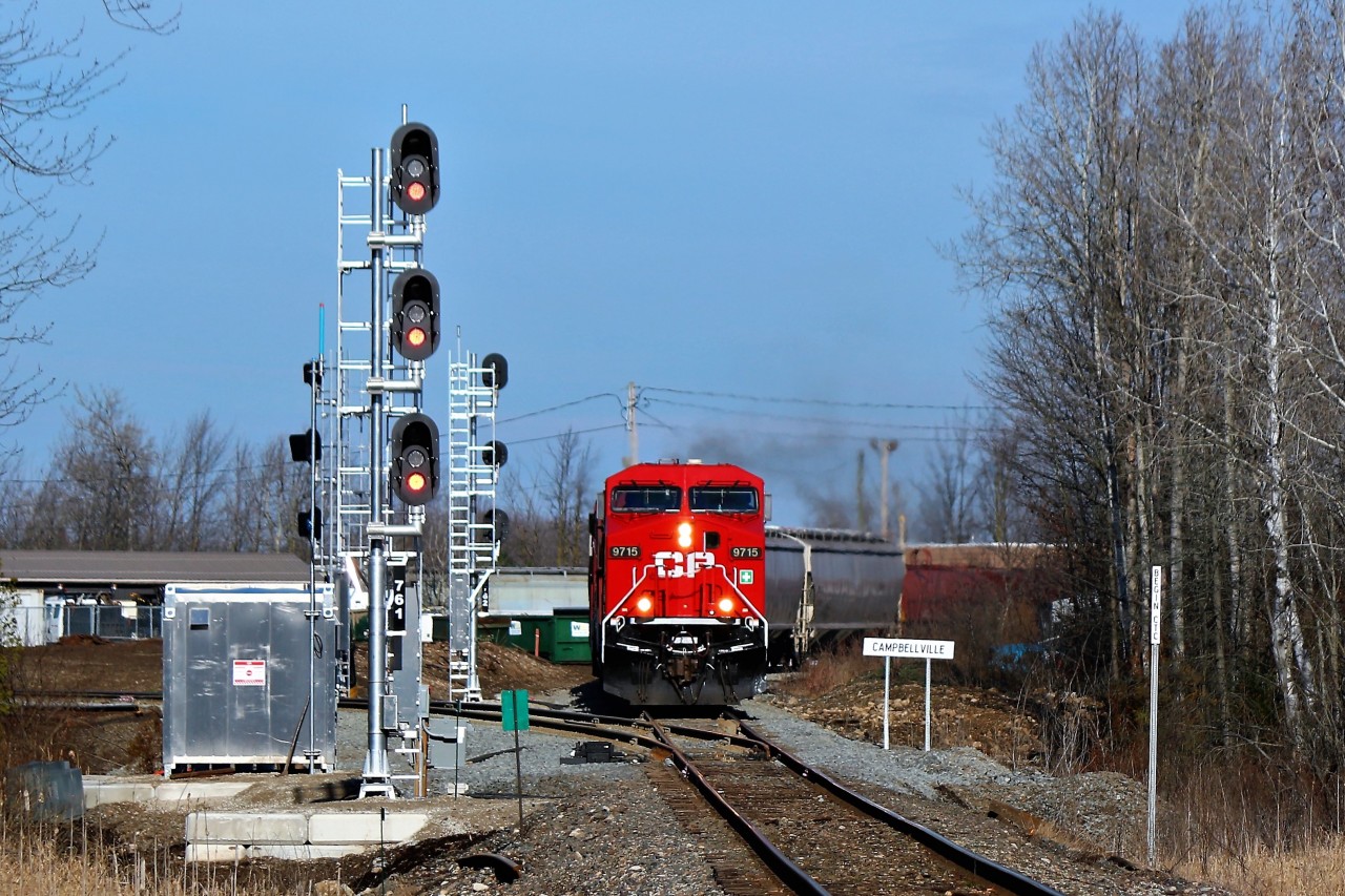 A freshly refurbished CP 9715 leads CP 246 past the newly installed signal lights, name sign and RTC controlled switch on its way down the Hamilton sub,