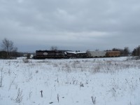 Shades of black and grey. On a grey day, 1001 returns from Innisfil with an empty tank car from Comet Chemical and a couple of loads for Tag Environmental. 