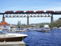 Well with today's powerful AC4400CWs and ES44ACs handling most of the tonnage to and from the west, one would be very hard pressed to see a set of locomotives like this any more. Even 30 years ago when I shot this, it was a real treat. Here was have 5 SD40-2s running northward over the Sequin River at Parry Sound: CP 6004, 5905, 5670, 6014 and 5909. Note the local feller down on the dock. He isn't the least bit interested.