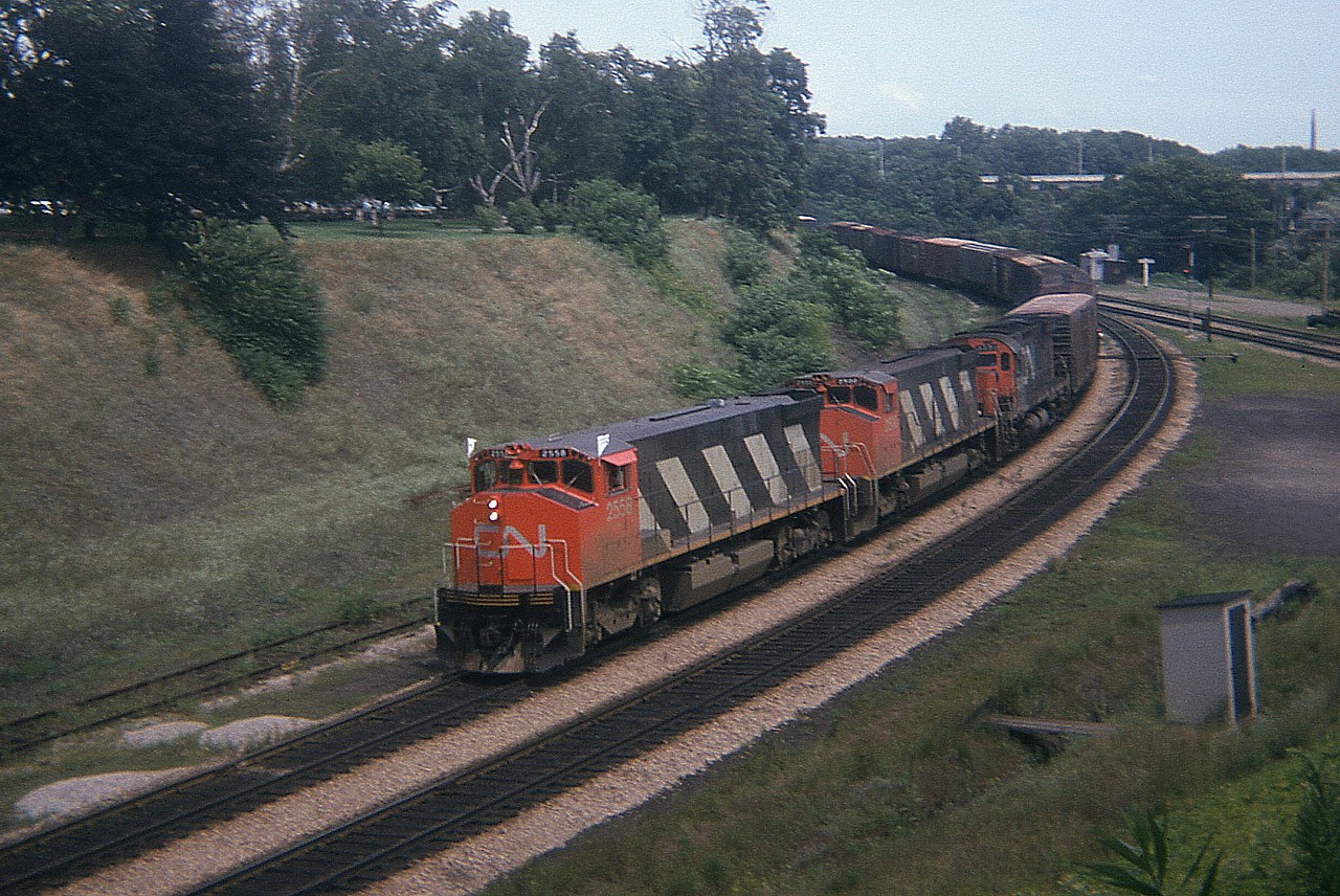 I know, whine, whine, whine..........but when I look at images like this I am so disappointed that the landscape cannot be like it used to be. Bayview looks 'manicured'. That lawn out there, even within the junction itself, looks better than mine. This image was taken on a weekday in July of 1974 but I have no indicated the exact date on my pic, unfortunately. Problem was back then I did not expect the hobby to evolve as it did. I've not a record of the two units behind 2558 as it makes it's way off the Oakville sub westbound  toward London. That little building in the right bottom corner always intrigued me. Back then, I thought it was an outhouse. In 1975, vandals tipped it over, and that was the end of it. I never did give it an "inspection". But seeing this shot, well, there is no window, no exhaust,any of those old railway guys would be gasping and choking in a hurry. So it must have been some sort of communications shack? I never did find out. It has been so long ago now there is nobody to ask.
The series 2500-2579, M420s, were renumbered into the 3500 series by end of 1987.