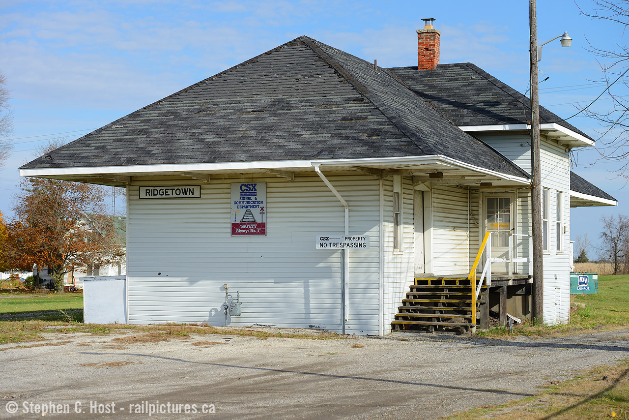 If only I'd seen a train here - I'd be in heaven, but I have to resort to the kind folks who share their memories on this site and elsewhere as I was a bit too young when this all came to an end. I'm not much of a station photographer, but having spent a lot of time documenting the CSX/C&O remnants in Ontario over the years I had to make the trip to Ridgetown to photograph it and this is my effort. And guess what, it's still there and still the Signals department HQ in 2017. Will it last into 2018 is the question.. and for how much longer?
For a view in 1976 see Arnold's photo  here 
And some interesting tidbits that may shed light into why all of this still exists despite being 50 miles from live rail:
The Lake Erie and Detroit River Railway company STILL exists
The LE&DR Continued to meet in Walkerville, annually to conduct their AGM as little as 8 years ago
The LE&DR's office is now in Toronto at the Royal Bank Plaza (Likely just a paper office) however
The LE&DR has three directors, two in Jacksonville, and one in Montreal, a CSX Traffic manager.
CSX has only 30 subsidiaries and most are real estate or other non transportation assets, the LE&DR is one of the handful of remaining transportation subsidiaries existing as part of CSX in 2017. The Montreal division is the St. Lawrence and Adirondack Railway company and is operated in a similar manner.
It's my knowledge, aside from some land in St. Thomas (Tim Hortons) the entire right of way from St. Thomas to Windsor  is still owned by the LE&DR and leased to CSX, except for the Windsor/Walkerville portions which are leased to CN. I don't think much if anything has been sold off for real estate purposes, etc. Heck, St. Thomas is still a brownfield and the turntable pit is still in place... Canadian real estate should be quite valuable to any US company - you can buy 10 houses in Deslher or Fostoria for the price of a single plot of land in Ontario.
Sarnia to Wallaceburg is also still owned by the LE&DR and leased to CSX as part of a running rights agreement.
Chatham to Blenheim  - the rail, ties, and signals above the dirt is owned by CN, but the land is STILL owned by LE&DR and leased to CN - when CN leaves town, LE&DR still owns the right of way - this was the deal struck in 2006.
Chatham to Wallaceburg, should have been fully transferred to the region of Chatham-Kent and LE&DR SHOULD have no ownership interest in it of any kind - the only reason I say should is I haven't seen the contract.. and you just don't know what was agreed to.

So are you surprised why so little has changed? I still wonder if there are non CSX Shareholders still owning stock in the LE&DR and if this is why it has yet to be amalgamated entirely into CSX - a descendent of the LE&DR in the Walkerville area getting dividends after 100 years - the Sarnia traffic would be worth a pretty penny. We'll see what Hunter Harrison has in store but you know he can't leave things be..

Sources for the above: Canada Gazette, Corporation annual filings (Gov't of Canada), CSX Annual filings, Canadian Transportation Agency filings (certificate of fitness 2015), press releases and financial reports circia 2006, and personal observations (maps.google.com and/or google earth, etc)