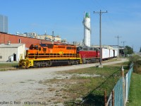 If there's one thing the Southern Ontario Railway Hagersville division is not known for, is photos of SOR trains switching customers. Of the five or six along the line, only two are accessible or near public property, the rest are deep in large inaccessible complexes. Furthermore, the two accessible customers are switched by the Paris turn in darkness, so when in September and October the Paris turn was ordered 1500, the chances of finding a daylight run finally became possible. I had imagined this scene years prior in my drives to Port Dover and was finally able to make it happen. Thanks to RP.CA contributor Glenn Cherry for use of his convenient ladder to make this possible.<br><br>While shooting here Security were very interested in us - we're basically just beside the reserve and tensions were high - but they were Ok with our  presence when we noted the train is our subject. <Br><br>CGC, the Canada Gypsum Company has been operating a Gypsum mine here since 1931 and is the last mine operating in the area, once numbering in the dozens. CGC (now part of USG) conveniently processes it on-site into wallboard for shipment to the US - the place is BUSY and if they miss a switch, the plant will shut down with no where to stockpile the product. As a result, they were also getting switched 5 or 6 days a week and were the main reason 597 continued to run while Imperial Nanticoke was shut down. This day they were so hurting for cars that upon arrival, they were met by a Trackmobile who quickly grabbed one empty and shoved it into the plant while the SOR lifted the loads and set off the empties. CGC also receives the odd car of plaster, pearlite and starch and various hoppers are noted in the tracks on north side of the building. CGC loads both Centrebeams and Boxcars for outbound shipments. CGC does not ship any outbound Gypsum by rail at this time.<br><br>Note that I did significant research into this facility including speaking to the Company directly, so if you use any of this info you can source this post. Thanks!
