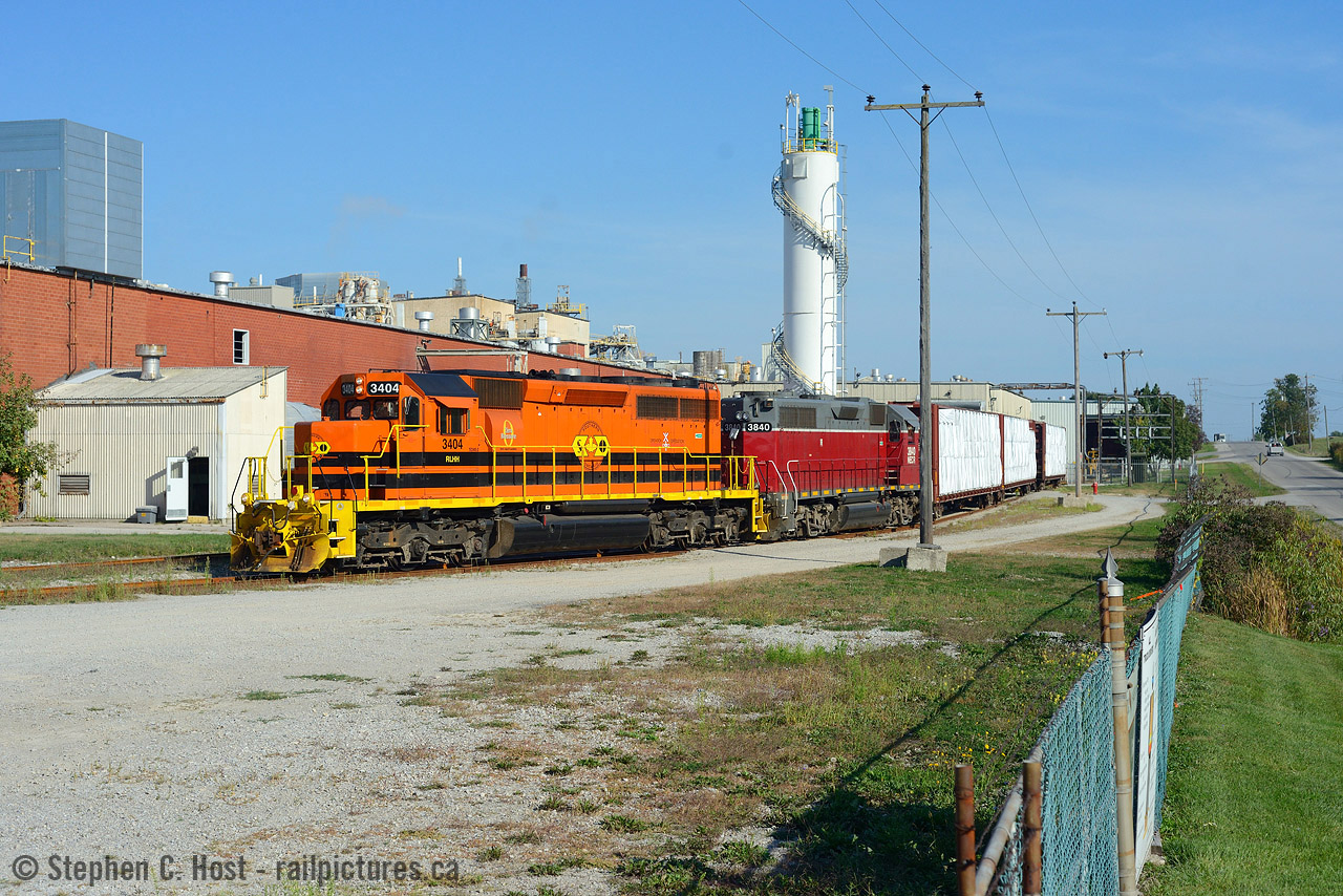 If there's one thing the Southern Ontario Railway Hagersville division is not known for, is photos of SOR trains switching customers. Of the five or six along the line, only two are accessible or near public property, the rest are deep in large inaccessible complexes. Furthermore, the two accessible customers are switched by the Paris turn in darkness, so when in September and October the Paris turn was ordered 1500, the chances of finding a daylight run finally became possible. I had imagined this scene years prior in my drives to Port Dover and was finally able to make it happen. Thanks to RP.CA contributor Glenn Cherry for use of his convenient ladder to make this possible.
CGC, the Canada Gypsum Company has been operating a Gypsum mine here since 1931 and is the last mine operating in the area, once numbering in the dozens. CGC (now part of USG) conveniently processes it on-site into wallboard for shipment to the US - the place is BUSY and if they miss a switch, the plant will shut down with no where to stockpile the product. As a result, they were also getting switched 5 or 6 days a week and were the main reason 597 continued to run while Imperial Nanticoke was shut down. This day they were so hurting for cars that upon arrival, they were met by a Trackmobile who quickly grabbed one empty and shoved it into the plant while the SOR lifted the loads and set off the empties. CGC also receives the odd car of plaster, pearlite and starch and various hoppers are noted in the tracks on north side of the building. CGC loads both Centrebeams and Boxcars for outbound shipments. CGC does not ship any outbound Gypsum by rail at this time.
Note that I did significant research into this facility including speaking to the Company directly, so if you use any of this info you can source this post. Thanks!