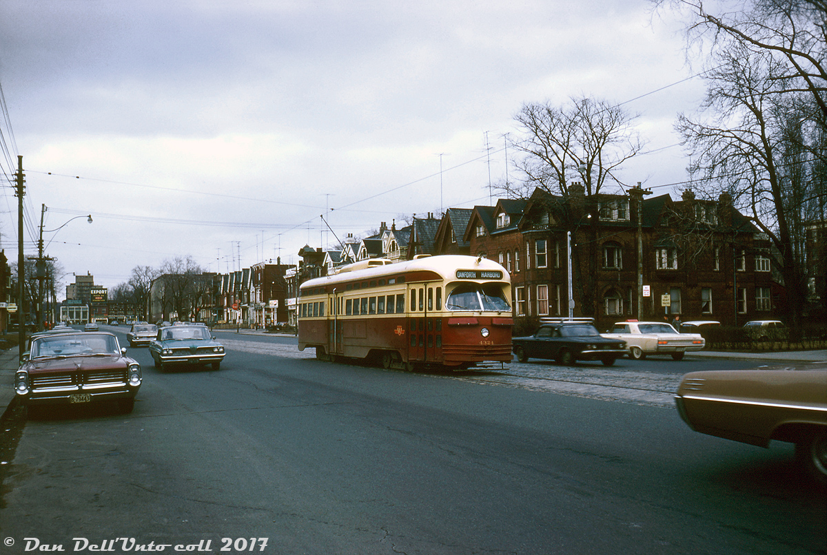 On a gloomy February day, TTC PCC 4324 operates on an eastbound Harbord car (detouring via Bloor instead of the normal Harbord routing) heading southbound on Spadina Avenue approaching Harbord Street, passing Glen Norris. The Harbord streetcar was a zig-zagging route across the city from St. Clarens loop (Davenport & Lansdowne area) to Lipton Loop (Danforth and Pape) traversing various streets including a stretch of Harbord between Spadina and Ossington. It was another one of the many streetcar route casualties when the Bloor-Danforth subway opened a year later.Despite the changes to Spadina over the years like the dedicated streetcar right-of-way and underground Spadina streetcar station, most if not all of those old houses on the east side remain to this day, not (at least yet) swallowed up by the neighbouring University of Toronto St. George campus (the UofT's large Graduate House building now occupies the space at the north-east corner of Spadina and Harbord however, just out of frame to the right).John F. Bromley photo, Kodachrome from the Dan Dell'Unto collection (with some colour correction/touch-ups).
