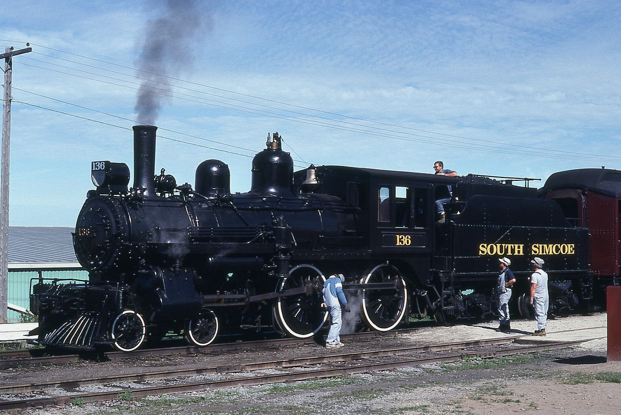 The South Simcoe Railway Heritage Corporation's Rogers 4-4-0 #136 is probably about the most famous locomotive operating in the country. It starred in the 1970's CBC television production, "The National Dream" which is what it is known best for, but it also took part in the famous (for train buffs) 1960 Triple Header fantrip in Ontario. I was fortunate enough to ride behind her and the #1057 back in 1974 on a trip to Owen Sound from Toronto and return, which was a Credit Valley Rwy excursion. This rather attractive steam engine was built way back in 1883, and spent many years under the Canadian Pacific banner. Now, it is semi-retired to the South Simcoe Railway, a short Tottenham to Beeton tourist run. It underwent restoration recently, returning to service on the railway in 2011. In this image, it looks as if the 'boys' are giving it a 'once-over' before they start the day's runs.
