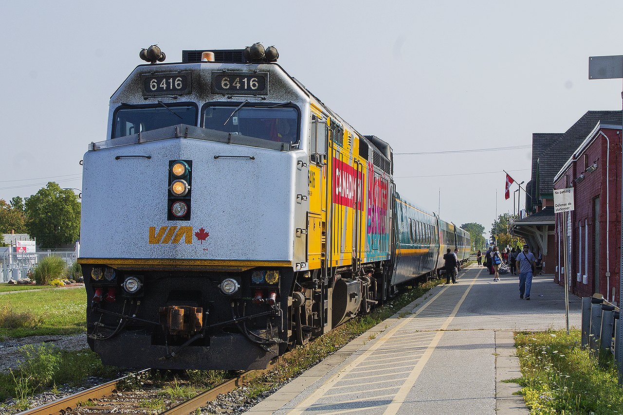 The traveler's assemble and prepare to board VIA Train 71 as it pulls into the Chatham station. On point is the 'Canada 150' wrapped F40PH 6416.