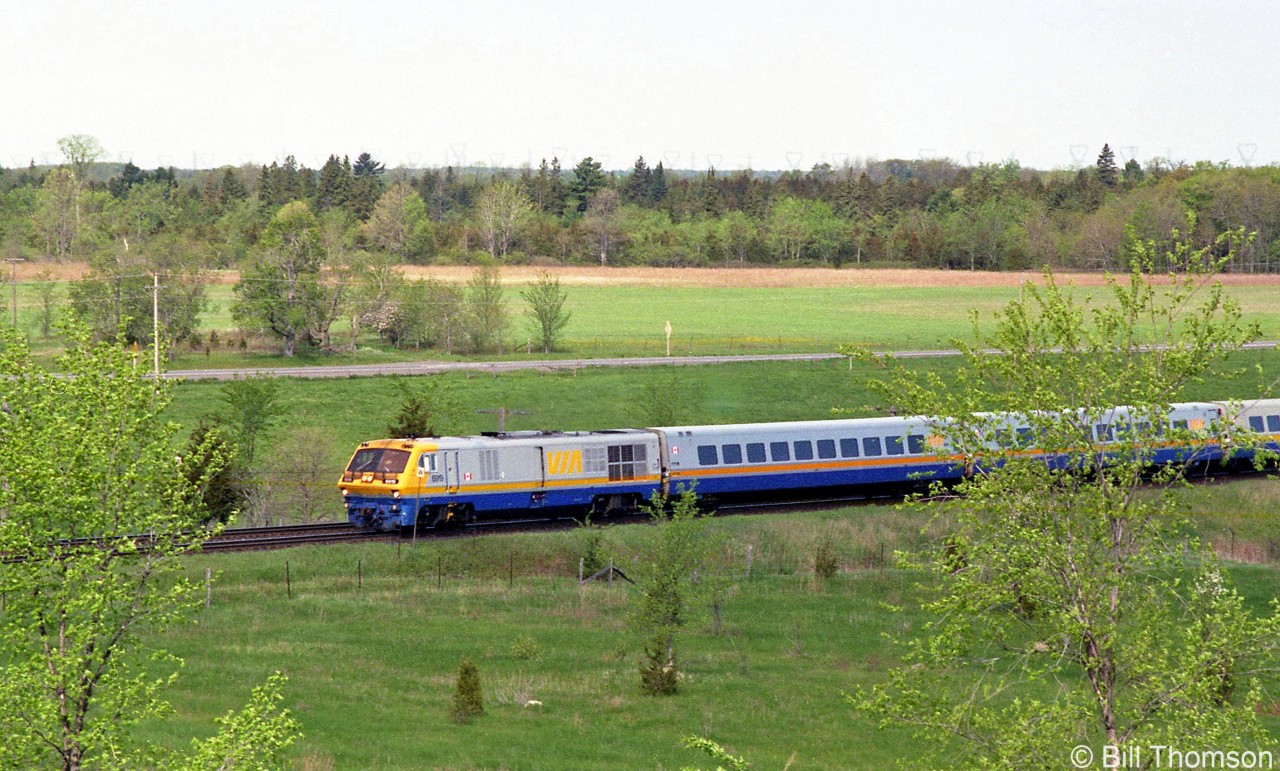 VIA LRC 6919 leads an eastbound passenger train at Mile 184 Kingston Sub (near County Road 6) in the Summer of 1995, with only eight more miles until arrival at the Kingston VIA station.