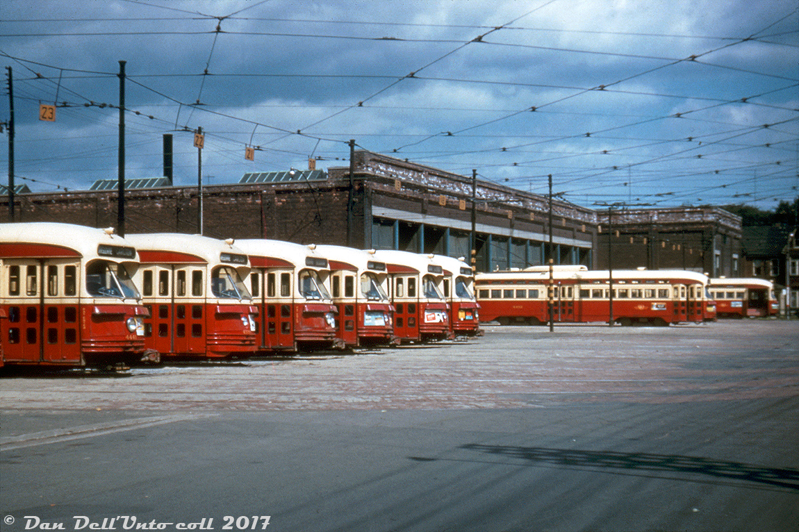 Lined up and ready to be dispatched for evening rush hour duties, TTC 4441 and a bunch of her sister PCC cars crowd the yard tracks outside Lansdowne Carhouse under cloudy afternoon skies in August of 1955. The route display rollsigns (front, right side) on the closest cars show Carlton for their last assignment, while the destination rollsigns (front, left side) say Lansdowne, for when they short turned and headed back to the carhouse at the end of morning service. Note some still have the front silver headlight ring that was being removed from all of the cars.

Eventually peaking at a total of 745 new and secondhand cars, by this time in the 50's Toronto's PCC streetcar fleet was the largest in North America (and by extension, the world). The opening of the Bloor-Danforth subway and its extensions in the mid-late 60's saw many of the older cars retired and disposed of, and some secondhand cars were sold off in the 70's to other transit agencies. The bulk of the PCC fleet were phased out in the 80's by new CLRV and ALRV streetcars, with a select few rebuilt and living on in harbourfront service before being retired and sold off in the late 90's. Two PCC streetcars, 4500 & 4549, were kept and are used on occasion for special event and charter service.

Original photographer unknown (Al Chione duplicate slide), from the Dan Dell'Unto collection.