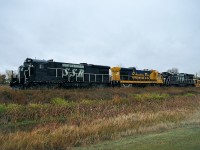 The Stewart Southern, which runs from the CP Indian Head Sub near Regina, goes as far as 80 miles SE to Stoughton, SK. Just north of the main business area were these units off the main; assumption was it was either quiet around this time or perhaps some trackwork was taking priority, judging by the equipment behind the power. The units and all are on a stub track between the mainline and the highway by which I am standing. Power is SSR 1010, 4255 and 1009. I would have liked to hang around a couple of days but the weather forecast was for a major snowstorm even though it was only the beginning of October. Another time................. Current CTG lists 9 units on their roster,the balance were probably up at Fillmore, the road's headquarters.