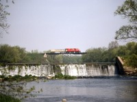 After its weekend lay over in London, 528 with only the adapter trailer crosses the trestle at Thamesford on its way to lambton yard and the westbound traffic. In the early start up of the road railer the east bound train would run light from Detroit and tie up in London on the weekend.  