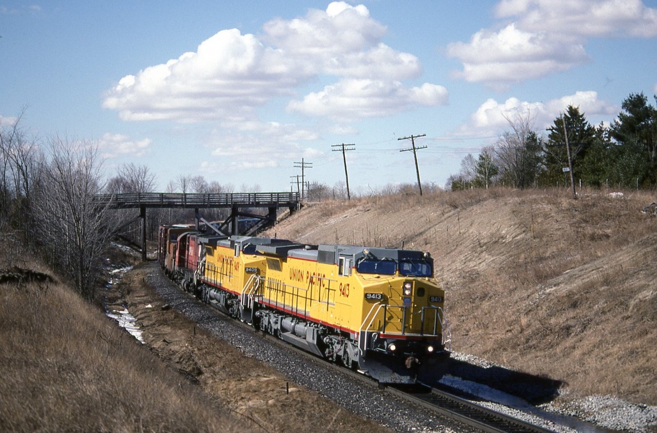 Test units from, GE, UP 9413 and 9409 lead CP 4217 on train 508 around the curves at Audley passing under Salem Road. With another GE, UP unit and several BC Rail dash 8s testing in coal train service out in western Canada. 26 years later its safe to say that testing proved successful for CP