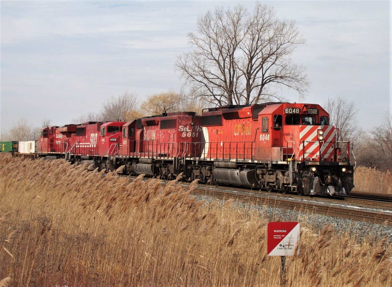 CP 6048, STL&H 5651, SOO 6062 and CP 8854 depart Windsor ahead of train 242 after making a lift in Walkerville Yard. The incredibly invasive, destructive Phragmites australis ssp. australis dominates the bottom left of the photo.